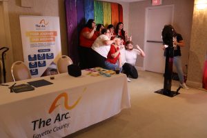 IMG_0679 People taking a picture at the Arc Fayette photo booth