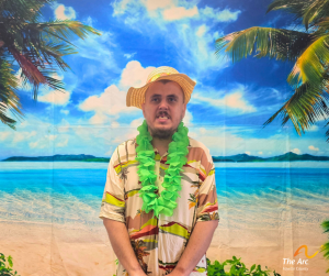 Guy posing in front of beach backdrop