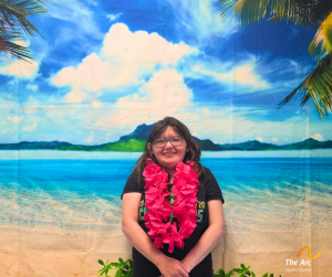 Woman posing in front of beach backdrop