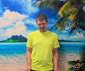 Guy posing in front of beach back drop