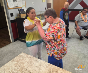 Two ladies dancing together and smiling