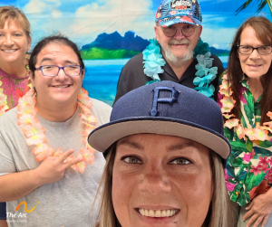 four teachers posing with one participant in front of beach backdrop