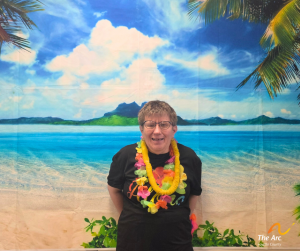Woman posing in front of beach backdrop