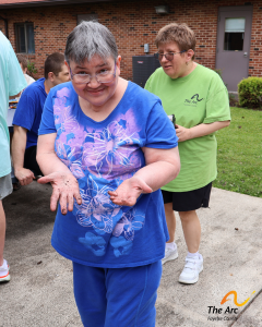 Adult Training Facility (ATF) participant showing their dirty hands from gardening.
